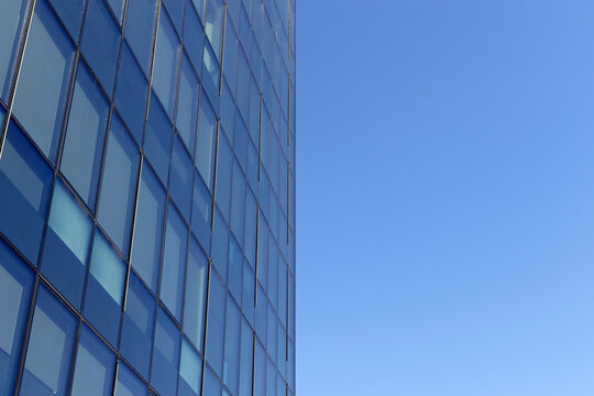 Downtown corporate business district architecture. Glass reflective office buildings against blue sky and sun light. Economy, finances, business activity concept. Copy space.