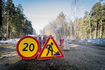 Reconstruction of the road. Signs for road repairs and speed limits on a dangerous section. Danger...