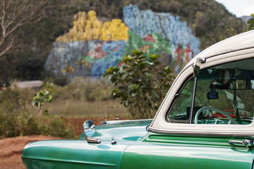 Old american car with colourful mural wall from Vinales, Cuba
