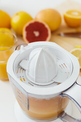 Closeup of citrus juicer full of fresh orange juice
