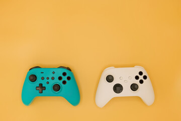 Joysticks gaming controller isolated on pastel yellow background, Video game console developed Interactive Entertainment © Nudphon