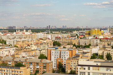 Obraz premium Kyiv, Ukraine – July 08, 2017: A beautiful panorama of Podil area. Aerial view on residential and industrial areas. A lot of buildings of different architectural style. Historical area, Dnipro river.