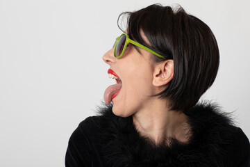 Woman sticks out her tongue on white background © alexandre zveiger