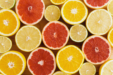 Different sliced citrus fruits such as grapefruit, orange, lemon and lime
