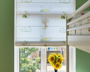 sunflower in the window, beautiful textiles on the window, fabric blinds