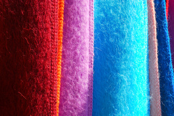 Close-up of variously colored Andes alpaca wool scarves for sale in a market in southern Chile