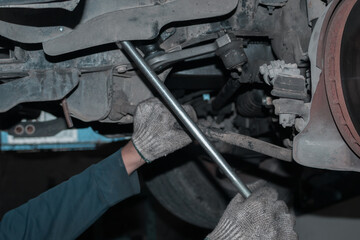 The mechanic is checking the engine.