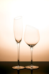 Transparent glass of wine with orange white background tone colour