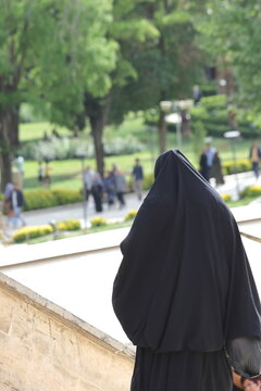 a woman in burka walking in the street