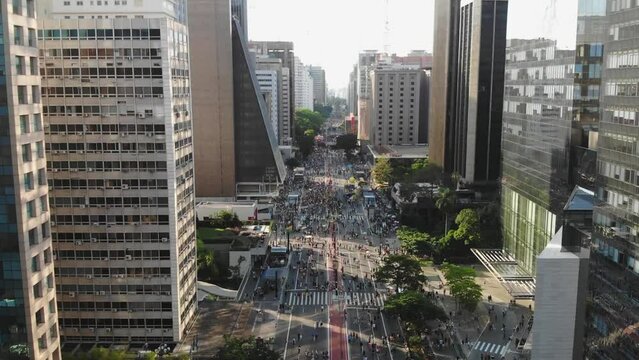 Drone Aerial View Of A Big City Main Street Filled With Many Pedestrians (Paulista Avenue, Sao Paulo, Brazil)