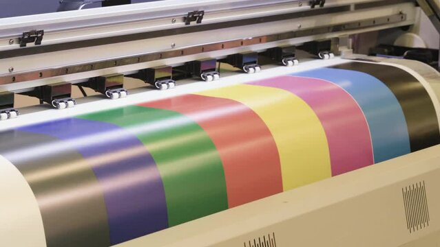Industrial printing on paper, modern digital inkjet printer puts a picture on paper