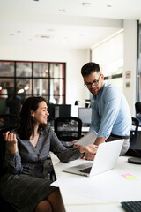 Colleagues in office. Businesswoman and businessman discussing work in office.