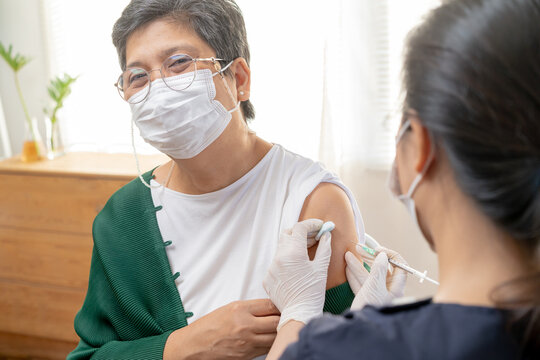 Covid-19,coronavirus, Elderly Asian Adult Woman Getting Vaccine From Doctor Or Nurse Giving Shot To Mature Patient At Clinic. Healthcare, Immunization, Disease Prevention Against Flu Or Virus Pandemic