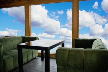 Table for two with sky view through the windows 