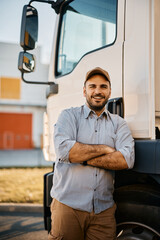 Portrait of confident truck driver with arms crossed looking at camera.
