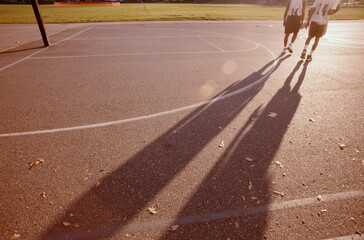 Sunset, two young basketball players