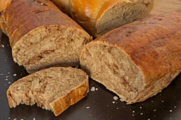 Bread in the shape of a braid. Sweet Challah. Slice of banana bread for breakfast, side view. Cherry tomatoes . High quality photo