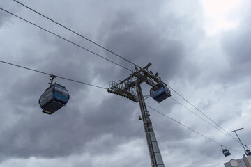 yellow cable car means of transport with a view of the city of bolivia and el alto in a sunset with blue sky and clouds with natural light