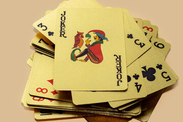 golden casino playing cards in a row or chaotic arrangement on orange background. four aces...