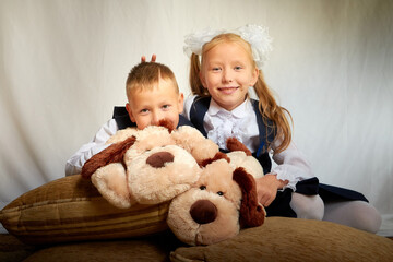 Girl and boy who is elementary school children in uniform having fun with toys Brother and sister...