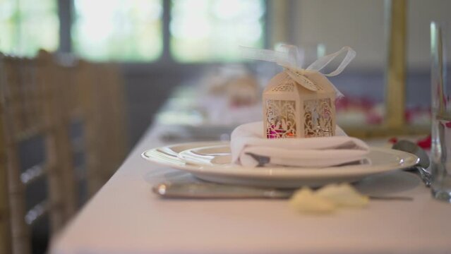 A beautiful shot of monogrammed wedding favour box for guest placed on table.