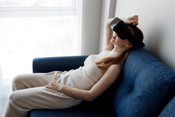 woman using vr glasses at home