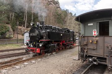 Obraz premium Historic steam powered railway train at train station Oybin. Saxony. Germany