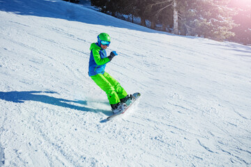 Action motion photo of a boy snowboard on mountain ski slope