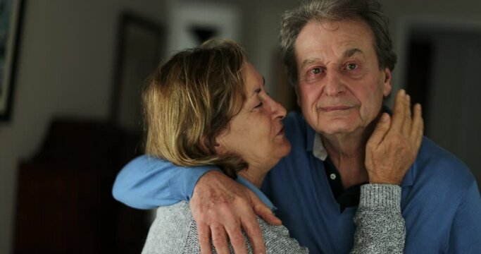 Senior wife kissing husband older couple love and affection