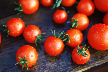 Ecological fresh farm cherry tomatoes on a wooden background.
