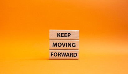 Keep moving forward symbol. Concept words keep moving forward on wooden blocks. Beautiful orange background. Business and keep moving forward concept. Copy space.