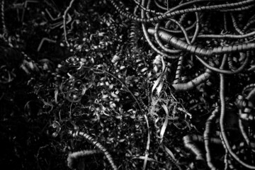 Metal scrap closeup - Lathe steel fillings in black. Recycling materials from manufacturing process.