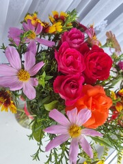 close-up photo of red and pink flowers. It is invitation, gift and a present. Concept of taking care and surprises