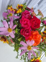 close-up photo of red and pink flowers. It is invitation, gift and a present. Concept of taking care and surprises
