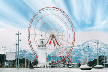 Batumi, Adjara, Georgia. Ferris Wheel At Promenade In Miracle Park, lighthouse Amusement City Park. altered sky.