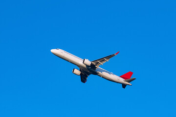 Jet plane after lift off isolated on blue sky on a summer day in Cologne  Germany. Starting...