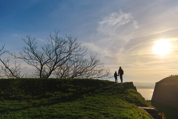 Fototapeta premium Silhouette of Father and Son in Serbia at Sunset