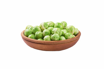 fresh brussel sprouts in a wooden bowl isolated on white background.