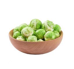 organic brussel sprouts in a wooden bowl isolated on white background.