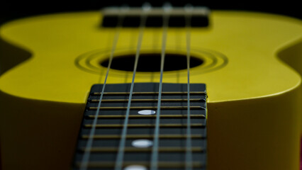 Fototapeta premium close up ukulele, yellow guitar with strings