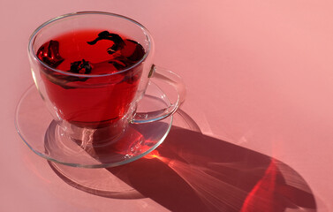 Tea cup on pink background, close-up, light and shadow