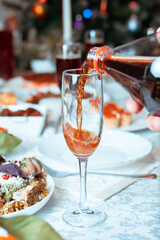 Lemonade is poured from a bottle into a glass on a holiday   