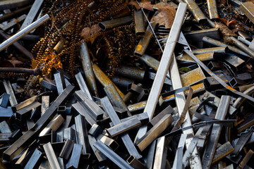 Metal scrap from the manufacturing process. Pile of steel waste prepared for recycling.