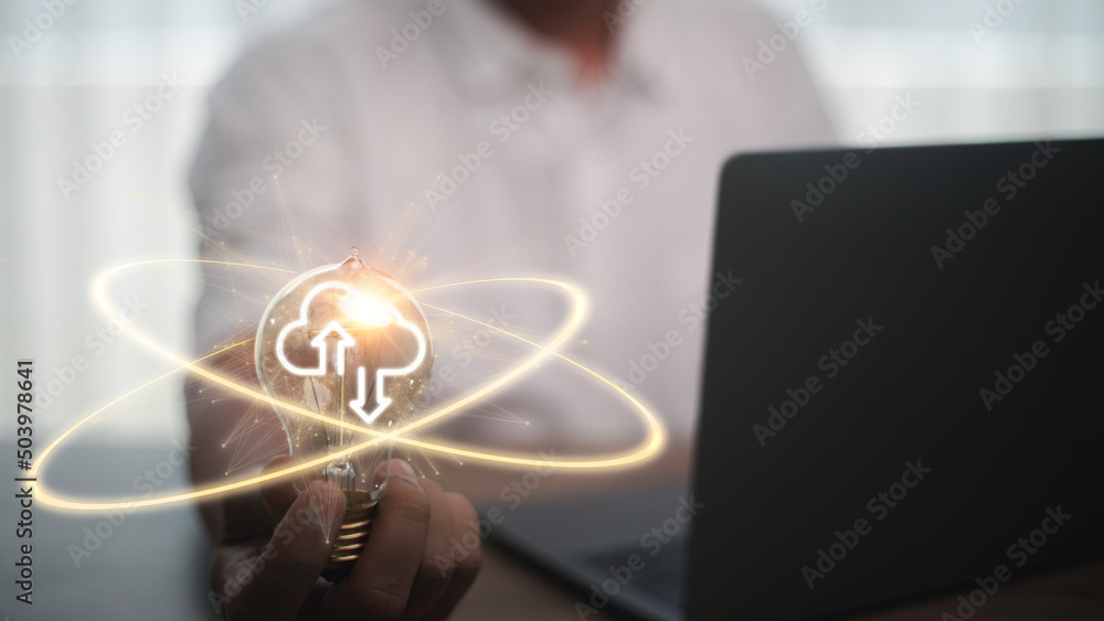 Poster hand holding lightbulb with cloud computing and technology icons such as laptop computer graph.cloud