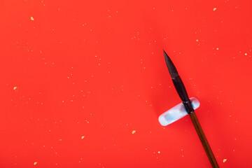 Brush and ink on red background