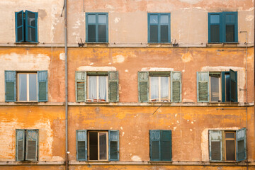 Fototapeta na wymiar Facade of an old building in Garbatella district in Rome, Italy. It is an old tenement building with windows only.