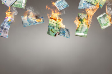 Burning Kazakh Tenge banknotes 