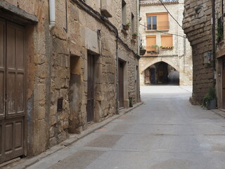 una de las muchas calles típicas del bonito pueblo medieval de vinaixa, con portales de piedra, arcos, lérida, españa, europa