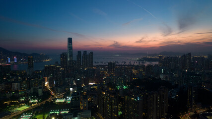 cityscape of Kowloon in Hong Kong, with the after glow of sky on the horizon of land