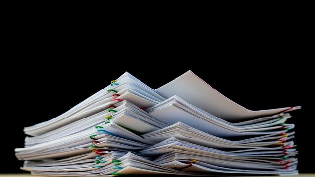 4K-Stop motion Stack overload document report paper with colorful paperclip on black background and copy space, business concept footage paperless used.